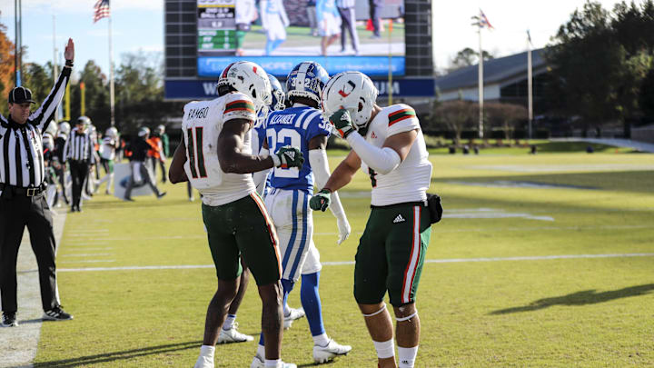 Nov 27, 2021; Durham, North Carolina, USA;  Miami Hurricanes wide receiver Charleston Rambo (11) and Miami Hurricanes wide receiver Xavier Restrepo (7) celebrate a touchdown during the second half of the game against the Miami Hurricanes at Wallace Wade Stadium. at Wallace Wade Stadium. Mandatory Credit: Jaylynn Nash-Imagn Images