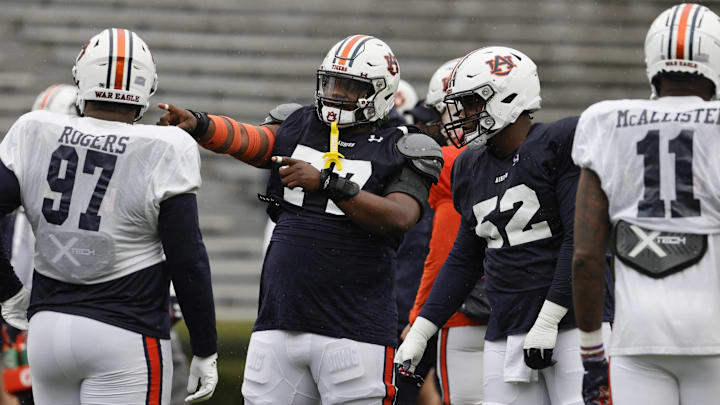 Apr 8, 2023; Auburn, AL, USA;  Auburn Tigers offensive lineman Jeremiah Wright (77) talks with lineman Dillon Wade (52) during the annual Auburn Spring Game at Jordan-Hare Stadium. Mandatory Credit: John Reed-USA TODAY Sports