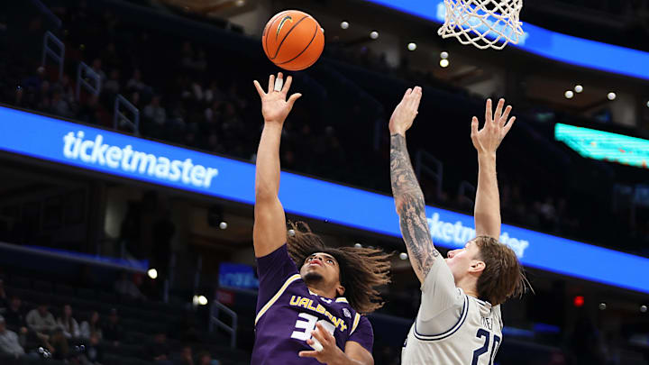 Nov 30, 2024; Washington, District of Columbia, USA; Albany Great Danes forward Justin Neely (33) shoots the ball against Georgetown Hoyas forward Drew Fielder (20) during the second half at Capital One Arena. Mandatory Credit: Daniel Kucin Jr.-Imagn Images