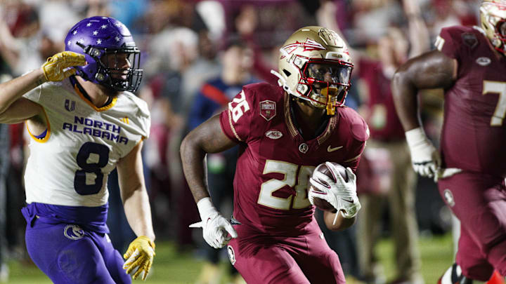 Nov 18, 2023; Tallahassee, Florida, USA; Florida State Seminoles running back Caziah Holmes (26) runs the ball in for a touchdown under pressure from North Alabama Lions linebacker Shaun Myers (8) during the third quarter at Doak S. Campbell Stadium. Mandatory Credit: Morgan Tencza-Imagn Images