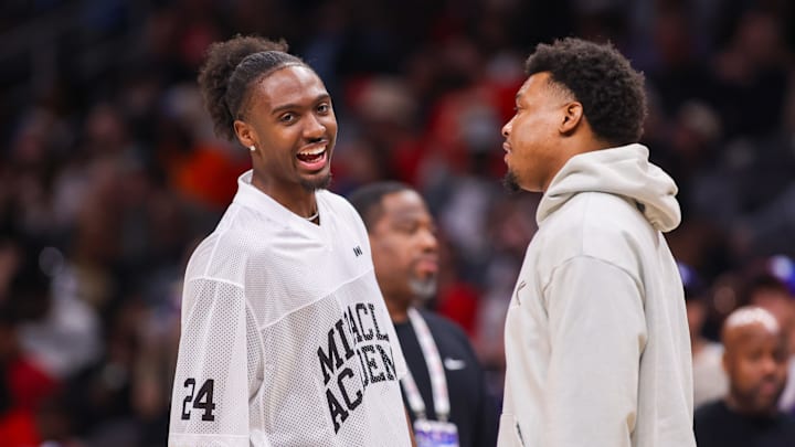 Mar 23, 2025; Atlanta, Georgia, USA; Philadelphia 76ers guard Tyrese Maxey (0) talks to guard Kyle Lowry (7) during a timeout against the Atlanta Hawks in the second quarter at State Farm Arena. Mandatory Credit: Brett Davis-Imagn Images