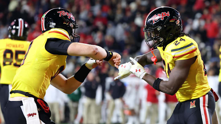 Nov 16, 2024; College Park, Maryland, USA; Maryland Terrapins quarterback Billy Edwards Jr. (9) and running back Roman Hemby (24) celebrate after a score against the Rutgers Scarlet Knights during the second half at SECU Stadium. Mandatory Credit: Daniel Kucin Jr.-Imagn Images