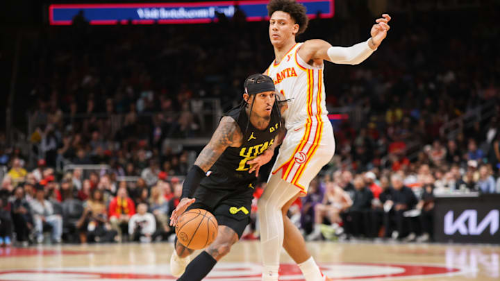 Feb 27, 2024; Atlanta, Georgia, USA; Utah Jazz guard Jordan Clarkson (00) drives past Atlanta Hawks forward Jalen Johnson (1) in the second half at State Farm Arena. Mandatory Credit: Brett Davis-Imagn Images