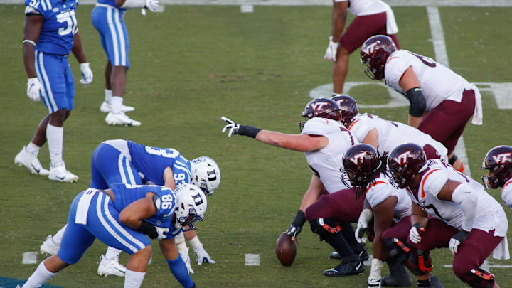 Oct 3, 2020; Durham, North Carolina, USA; The Duke Blue Devils defensive line, left, lines up against the Virginia Tech Hokies offensive line in the first half at Wallace Wade Stadium. Mandatory Credit: Nell Redmond-Imagn Images