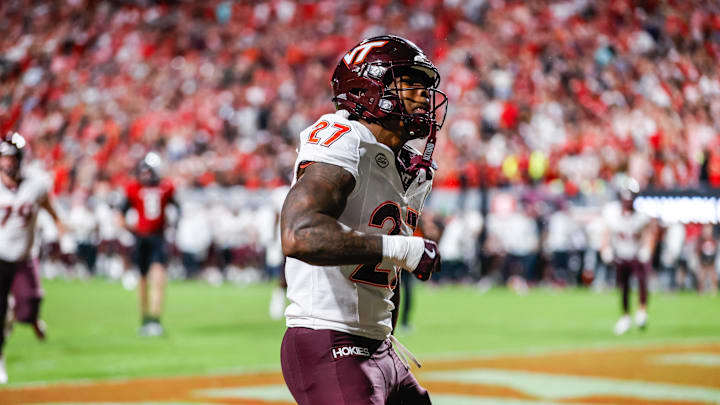 Sep 27, 2025; Raleigh, N.C.; Virginia Tech running back Marcellous Hawkins (27) makes a touchdown and celebrates during the first half of the game against N.C. State.
