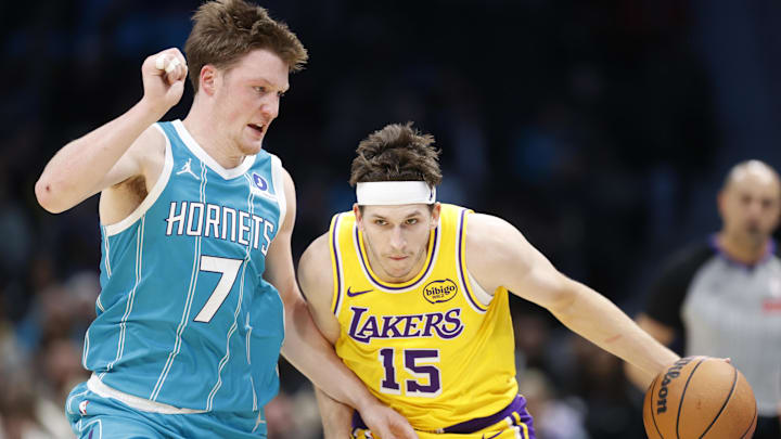 Nov 10, 2025; Charlotte, North Carolina, USA; Los Angeles Lakers guard Austin Reaves (15) tries to drive past Charlotte Hornets guard/forward Kon Knueppel (7) during the second quarter at Spectrum Center. Mandatory Credit: Brian Westerholt-Imagn Images