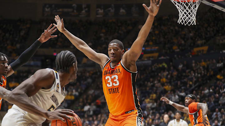 Jan 4, 2025; Morgantown, West Virginia, USA; Oklahoma State Cowboys forward Abou Ousmane (33) defends West Virginia Mountaineers guard Toby Okani (5) during the first half at WVU Coliseum. Mandatory Credit: Ben Queen-Imagn Images Jan 4, 2025; Morgantown, West Virginia, USA; Oklahoma State Cowboys forward Abou Ousmane (33) defends West Virginia Mountaineers guard Toby Okani (5) during the first half at WVU Coliseum. Mandatory Credit: Ben Queen-Imagn Images