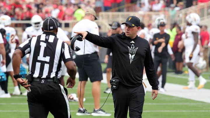 Sep 21, 2024; Lubbock, Texas, USA;  Arizona State Sun Devils head coach Kenny Dillingham visits with Big 12 official Lawrence Doss in the first half against the Texas Tech Red Raiders at Jones AT&T Stadium and Cody Campbell Field. Mandatory Credit: Michael C. Johnson-Imagn Images