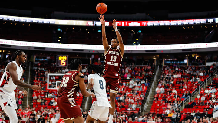 Feb 15, 2025; Raleigh, North Carolina, USA; Boston College Eagles guard Donald Hand Jr. (13) shoots a three pointer past forward Chad Venning (32) and North Carolina State Wolfpack guard Jayden Taylor (8) during the second half of the game at Lenovo Center. Mandatory Credit: Jaylynn Nash-Imagn Images Feb 15, 2025; Raleigh, North Carolina, USA; Boston College Eagles guard Donald Hand Jr. (13) shoots a three pointer past forward Chad Venning (32) and North Carolina State Wolfpack guard Jayden Taylor (8) during the second half of the game at Lenovo Center. Mandatory Credit: Jaylynn Nash-Imagn Images