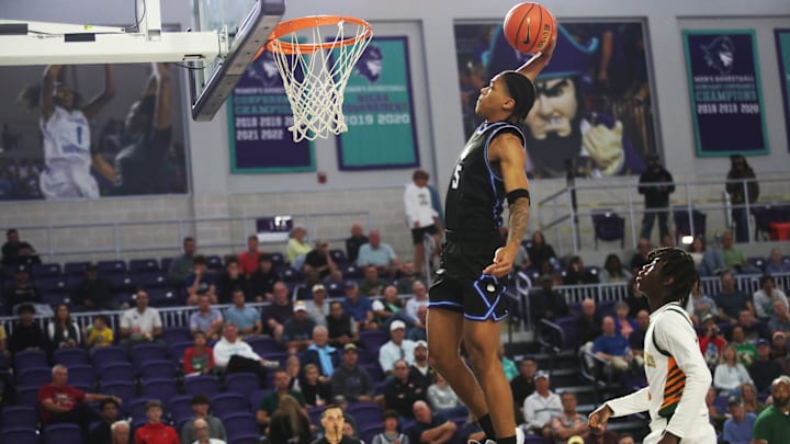 Darius Acuff Jr. from IMG Academy dunks against Oak Ridge during the third place game at the City of Palms Classic at Suncoast Credit Union Arena in Fort Myers on Monday, Dec. 23, 2024. IMG won.