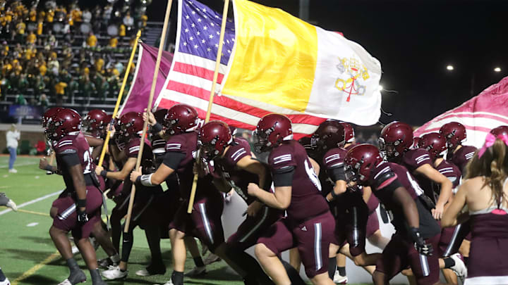 Benedictine players charge onto the field during their homecoming game against Ware County on Friday October 11, 2024 at Memorial Stadium.