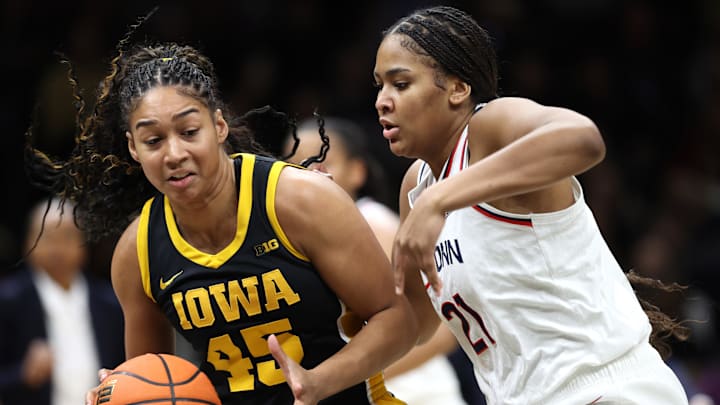 Dec 20, 2025; Brooklyn, New York, USA; Iowa Hawkeyes forward Hannah Stuelke (45) defends the ball from UConn Huskies forward Sarah Strong (21) during the first half at Barclays Center. Mandatory Credit: Pamela Smith-Imagn Images