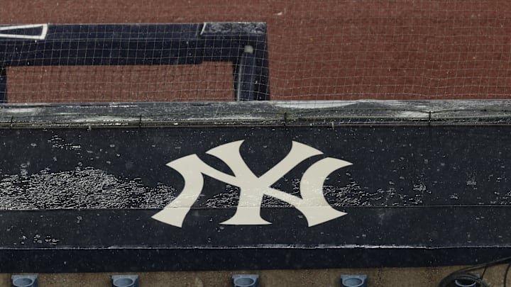 Aug 17, 2020; Bronx, New York, USA; A general view of rain falling on the  New York Yankees logo on the first base dugout roof during a rain delay in the game between the New York Yankees and the Boston Red Sox. Mandatory Credit: Vincent Carchietta-Imagn Images