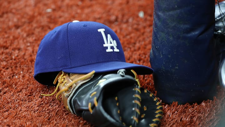 May 21, 2019; St. Petersburg, FL, USA; A detail view of Los Angeles Dodgers hat and glove at Tropicana Field. Mandatory Credit: Kim Klement-Imagn Images May 21, 2019; St. Petersburg, FL, USA; A detail view of Los Angeles Dodgers hat and glove at Tropicana Field. Mandatory Credit: Kim Klement-Imagn Images
