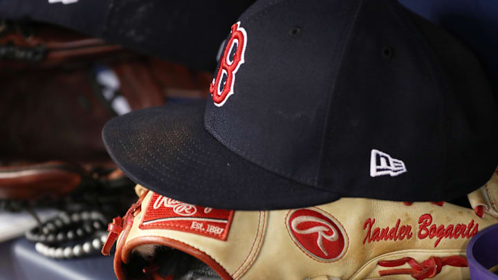 Mar 30, 2018; St. Petersburg, FL, USA; A detail view of Boston Red Sox shortstop Xander Bogaerts (2) (not pictured) baseball hat and glove in the dugout against the Tampa Bay Rays at Tropicana Field. Mandatory Credit: Kim Klement-Imagn Images
