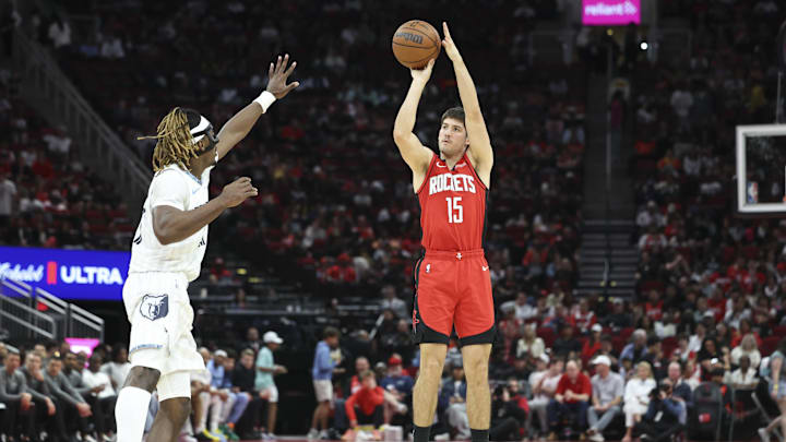 Apr 12, 2026; Houston, Texas, USA; Houston Rockets guard Reed Sheppard (15) shoots the ball as Memphis Grizzlies guard Jahmai Mashack (21) defends during the second quarter at Toyota Center. Mandatory Credit: Troy Taormina-Imagn Images