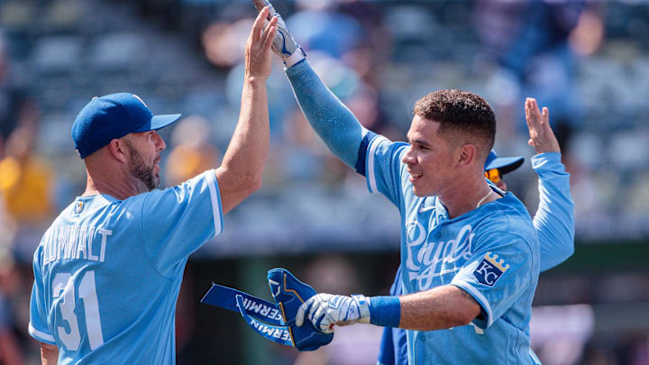 Jun 29, 2023; Kansas City, Missouri, USA; Kansas City Royals catcher Freddy Fermin (34) high fives Kansas City Royals senior director of hitting performance, major league hitting coach Alec Zumwalt (31) after a walk off during the tenth inning against the Cleveland Guardians at Kauffman Stadium. Mandatory Credit: William Purnell-Imagn Images