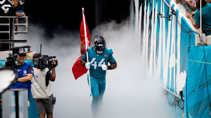 Nov 6, 2022; Jacksonville, Florida, USA; Jacksonville Jaguars linebacker Travon Walker (44) runs out of the tunnel with a Marines flag before the game against the Las Vegas Raiders at TIAA Bank Field. Mandatory Credit: Matt Pendleton-Imagn Images Nov 6, 2022; Jacksonville, Florida, USA; Jacksonville Jaguars linebacker Travon Walker (44) runs out of the tunnel with a Marines flag before the game against the Las Vegas Raiders at TIAA Bank Field. Mandatory Credit: Matt Pendleton-Imagn Images