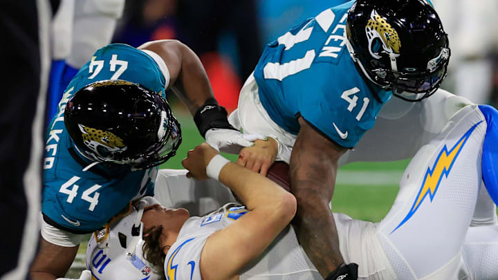 Jaguars linebacker Travon Walker (44) and linebacker Josh Allen (41) combine to sack Los Angeles Chargers quarterback Justin Herbert (10) during the second quarter of their come-from-behind wild-card playoff win in January 2023.