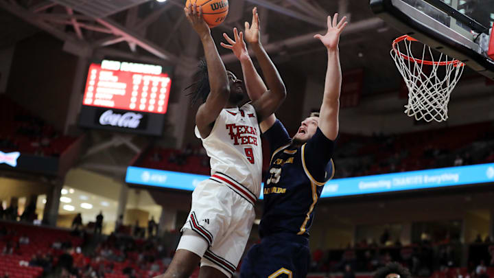 Dec 16, 2025; Lubbock, Texas, USA;  Texas Tech Red Raiders forward Luke Bamgboye (9) goes to the basket against Northern Colorado Bears center Egan Shields (33) in the first half at United Supermarkets Arena. Mandatory Credit: Michael C. Johnson-Imagn Images
