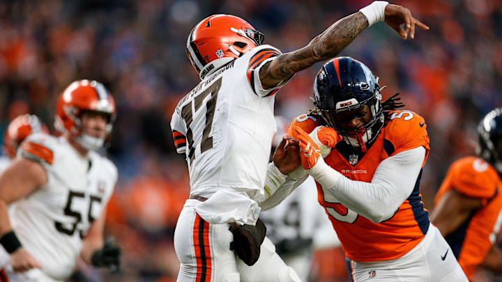Nov 26, 2023; Denver, Colorado, USA; Cleveland Browns quarterback Dorian Thompson-Robinson (17) is hit by Denver Broncos linebacker Baron Browning (56) in the third quarter at Empower Field at Mile High.