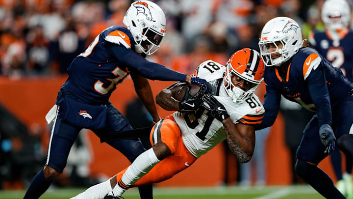 Dec 2, 2024; Denver, Colorado, USA; Cleveland Browns wide receiver Michael Woods II (81) is tackled by Denver Broncos cornerback Levi Wallace (39) and safety P.J. Locke (6) in the second quarter at Empower Field at Mile High. 