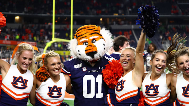 Aug 31, 2019; Arlington, TX, USA; Auburn Tigers mascot Aubie the Tiger celebrates with cheerleaders