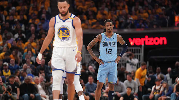 Memphis Grizzlies guard Ja Morant (12) looks towards Golden State Warriors guard Stephen Curry (30) during a break in the action in the second quarter at the Chase Center. 