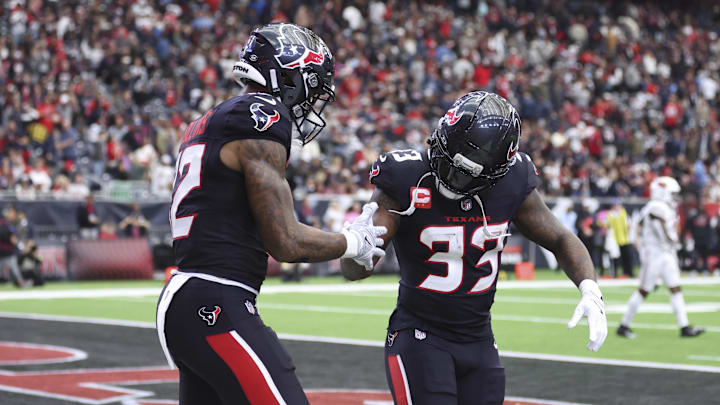 Dec 14, 2025; Houston, Texas, USA; Houston Texans wide receiver Nico Collins (12) celebrates with running back Dare Ogunbowale (33) after scoring a touchdown during the game against the Arizona Cardinals at NRG Stadium. Mandatory Credit: Troy Taormina-Imagn Images
