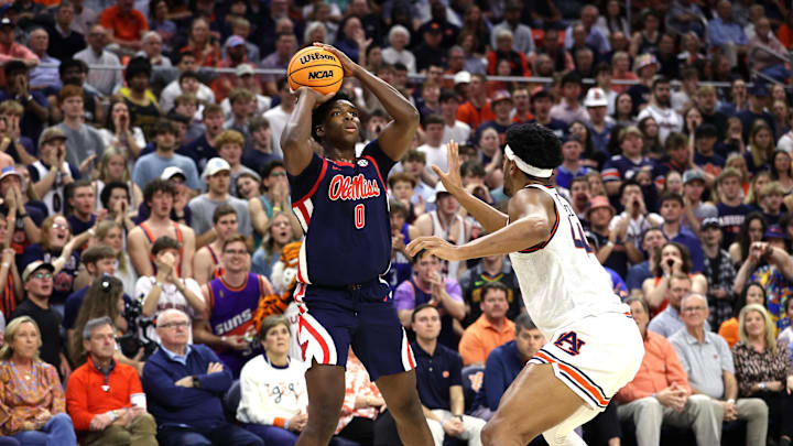 Feb 26, 2025; Auburn, Alabama, USA;  Mississippi Rebels forward Malik Dia (0) takes a shot over Auburn Tigers center Dylan Cardwell (44) during the first half at Neville Arena. Mandatory Credit: John Reed-Imagn Images