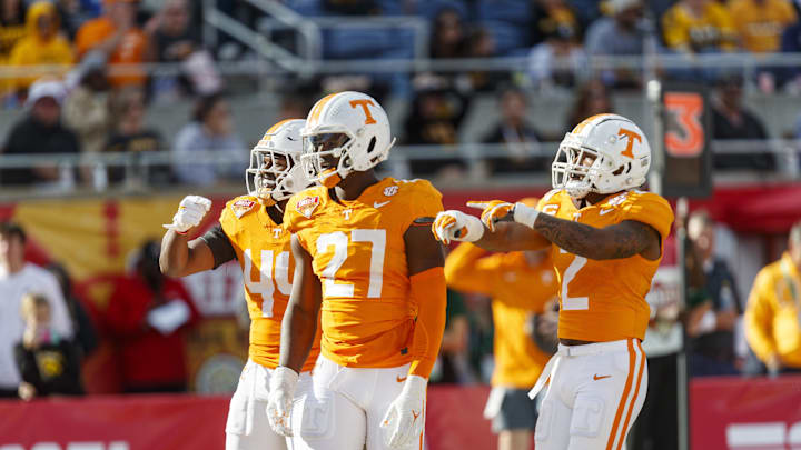 Jan 1, 2024; Orlando, FL, USA; Tennessee Volunteers defensive lineman James Pearce Jr. (27), linebacker Elijah Herring (44) and defensive back Jaylen McCollough (2) celebrate a sack against the Iowa Hawkeyes during the third quarter at Camping World Stadium. Mandatory Credit: Morgan Tencza-Imagn Images