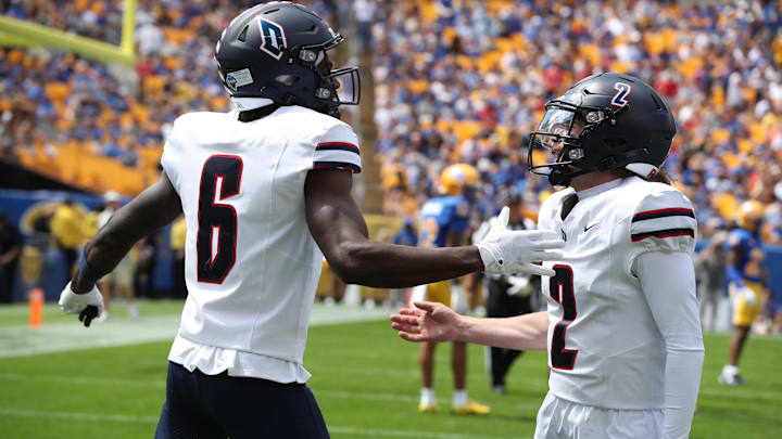 Aug 30, 2025; Pittsburgh, Pennsylvania, USA;  Duquesne Dukes wide receiver B.J. Alexander (6) and quarterback Tyler Riddell (2) celebrate after a touchdown against the Pittsburgh Panthers at Acrisure Stadium. Mandatory Credit: Charles LeClaire-Imagn Images