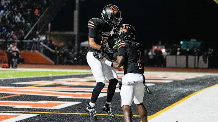 Belleville wide receiver Antwon Thomas, right, celebrate a touchdown against Saline with wide receiver Charles Britton III during the first half of district final at Belleville High School in Belleville on Friday, Nov. 8, 2024.