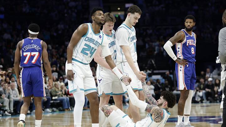 Charlotte Hornets guard LaMelo Ball (1) is helped up off the floor by teammates forward Brandon Miller (24), center Ryan Kalkbrenner (11) and guard/forward Kon Knueppel Charlotte Hornets guard LaMelo Ball (1) is helped up off the floor by teammates forward Brandon Miller (24), center Ryan Kalkbrenner (11) and guard/forward Kon Knueppel