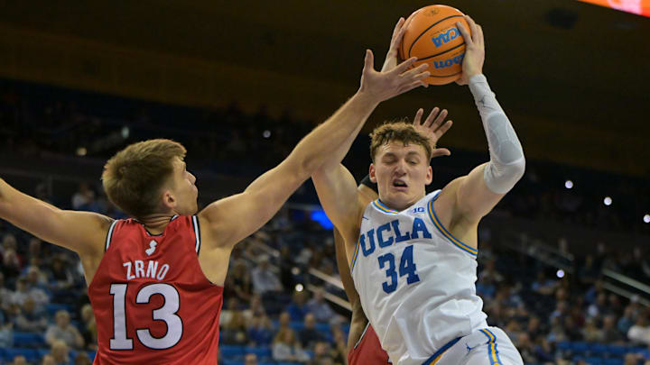 Feb 3, 2026; Los Angeles, California, USA;  UCLA Bruins forward Tyler Bilodeau (34) rebounds in front of Rutgers Scarlet Knights guard Harun Zrno (13) in the second half at Pauley Pavilion presented by Wescom Financial. Mandatory Credit: Jayne Kamin-Oncea-Imagn Images