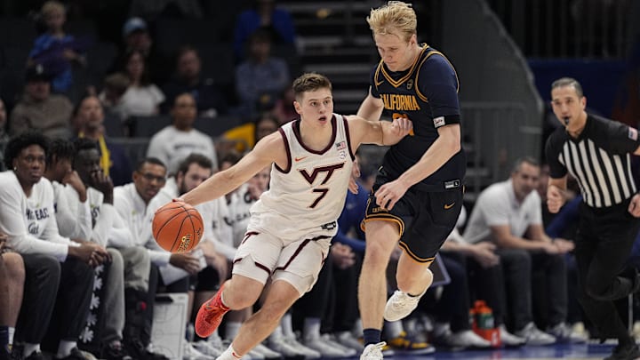 Mar 11, 2025; Charlotte, NC, USA;Virginia Tech Hokies guard Brandon Rechsteiner (7) tries to elude California Golden Bears forward Rytis Petraitis (31) during OT at Spectrum Center. Mandatory Credit: Jim Dedmon-Imagn Images