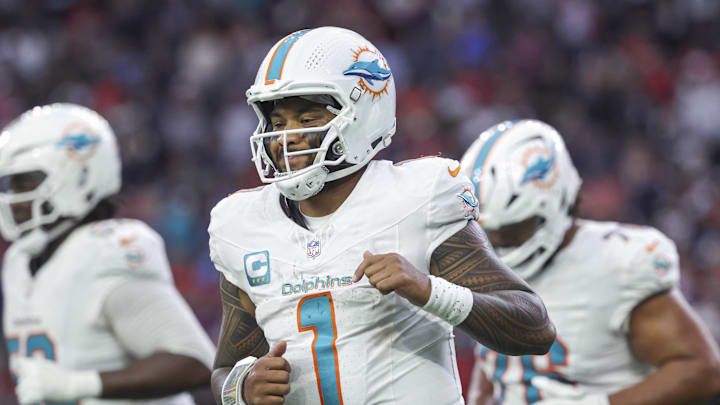 Dec 15, 2024; Houston, Texas, USA; Miami Dolphins quarterback Tua Tagovailoa (1) jogs off the field after a play during the fourth quarter against the Houston Texans at NRG Stadium. Mandatory Credit: Troy Taormina-Imagn Images