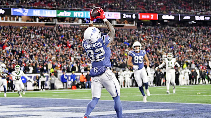 Nov 13, 2025; Foxborough, Massachusetts, USA; New England Patriots quarterback Drake Maye (10) throws a touchdown pass to New England Patriots running back TreVeyon Henderson (32) during the first half at Gillette Stadium. Mandatory Credit: Eric Canha-Imagn Images