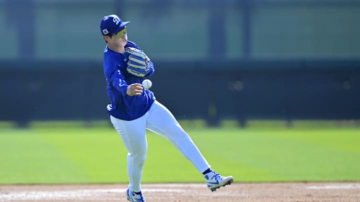 Feb 18, 2025; Glendale, AZ, USA;  Los Angeles Dodgers second baseman Hyeseong Kim (6) fields ground balls during spring training workouts at Camelback Ranch. Mandatory Credit: Jayne Kamin-Oncea-Imagn Images