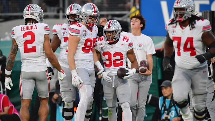 Jan 1, 2025; Pasadena, CA, USA;  Ohio State Buckeyes running back TreVeyon Henderson (32) celebrates with tight end Bennett Christian (85) after a touchdown in the third quarter against the Oregon Ducks in the 2025 Rose Bowl college football quarterfinal game at Rose Bowl Stadium. Mandatory Credit: Gary A. Vasquez-Imagn Images