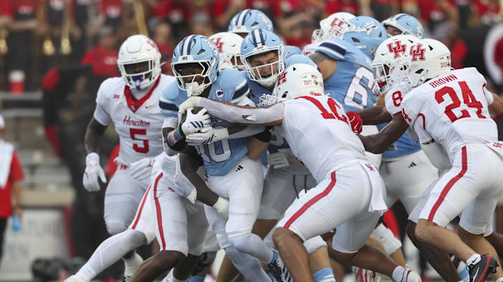 Rice Owls running back Quinton Jackson (10) runs with the ball as Houston Cougars linebacker Sione Fotu (12) defends during the second quarter at Rice Stadium. Rice Owls running back Quinton Jackson (10) runs with the ball as Houston Cougars linebacker Sione Fotu (12) defends during the second quarter at Rice Stadium.