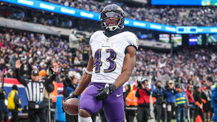 Dec 15, 2024; East Rutherford, New Jersey, USA; Baltimore Ravens running back Justice Hill (43) scores a touchdown reception during the second half against the New York Giants at MetLife Stadium. Mandatory Credit: Vincent Carchietta-Imagn Images