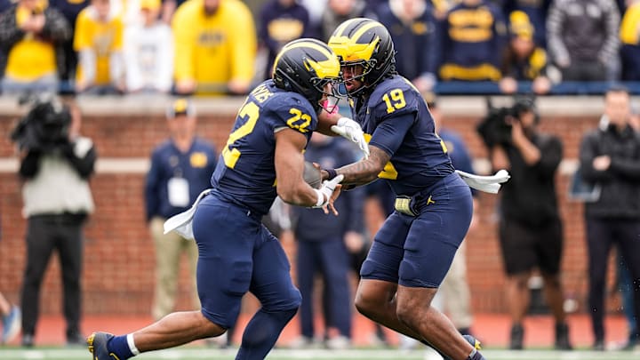 Team Blue quarterback Bryce Underwood (19) hands the ball to running back Justice Haynes (22) during the first half of the spring game at Michigan Stadium in Ann Arbor on Saturday, April 19, 2025.