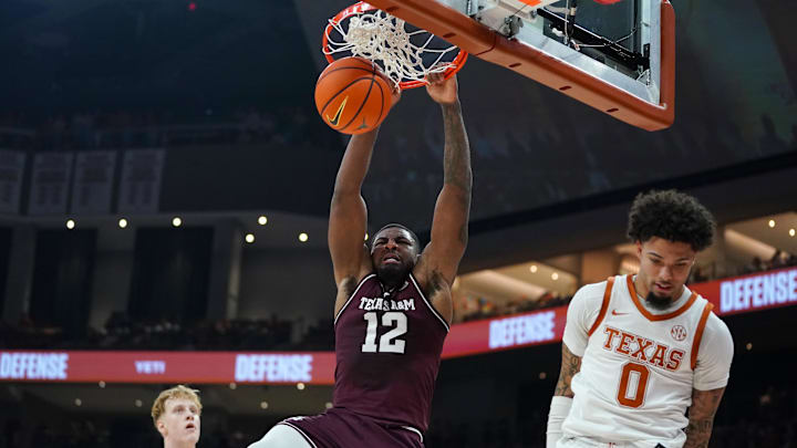 Jan 17, 2026; Austin, Texas, USA; Texas A&M Aggies forward Rashaun Agee (12) dunks against Texas Longhorns guard Jordan Pope (0) during the first half at Moody Center. Mandatory Credit: Dustin Safranek-Imagn Images