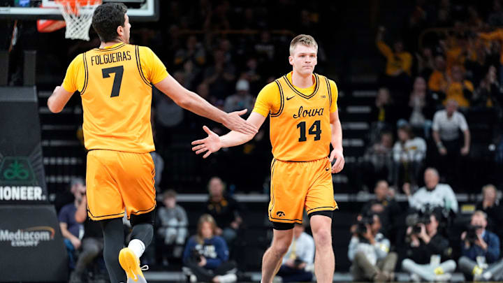 Iowa forward Alvaro Folgueiras (7) high-fives Iowa guard Bennett Stirtz (14) during a basketball game against the Maryland Terrapins Dec. 6, 2025 at Carver-Hawkeye Arena in Iowa City, Iowa. Iowa forward Alvaro Folgueiras (7) high-fives Iowa guard Bennett Stirtz (14) during a basketball game against the Maryland Terrapins Dec. 6, 2025 at Carver-Hawkeye Arena in Iowa City, Iowa.