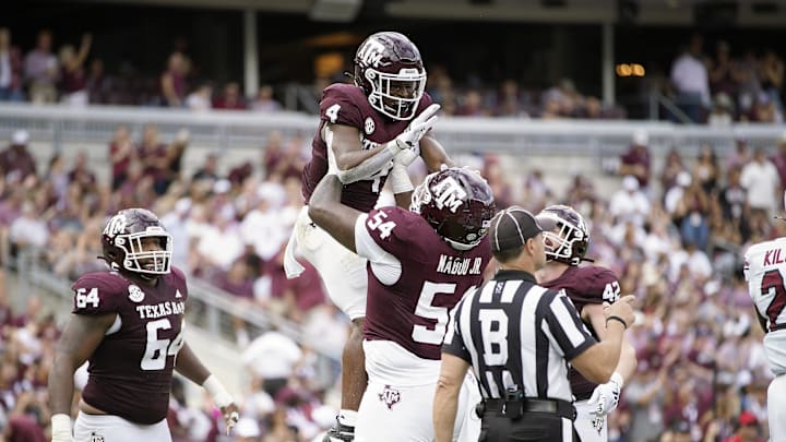 Oct 28, 2023; College Station, Texas, USA; Texas A&M Aggies running back Amari Daniels (4) and offensive lineman Mark Nabou Jr. (54) celebrate during the second quarter against the South Carolina Gamecocks at Kyle Field. Mandatory Credit: Dustin Safranek-Imagn Images