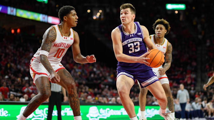 Mar 8, 2025; College Park, Maryland, USA; Northwestern Wildcats forward Luke Hunger (33) drives to the basket against Maryland Terrapins forward Julian Reese (10) during the first half at Xfinity Center. Mandatory Credit: Reggie Hildred-Imagn Images