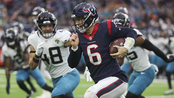 Jan 1, 2023; Houston, Texas, USA; Houston Texans quarterback Jeff Driskel (6) runs with the ball as Jacksonville Jaguars linebacker Chad Muma (48) attempts to make a tackle during the second quarter at NRG Stadium.