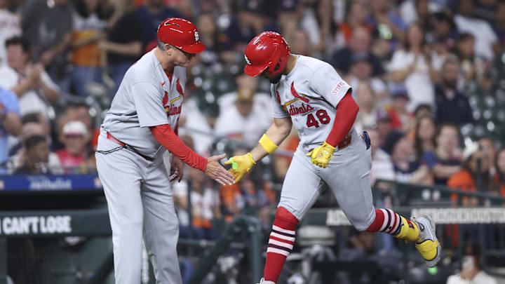 Apr 17, 2026; Houston, Texas, USA; St. Louis Cardinals designated hitter Ivan Herrera (48) celebrates with third base coach Ron 'pop' Warner (75) after hitting a home run during the eighth inning against the Houston Astros at Daikin Park. Mandatory Credit: Troy Taormina-Imagn Images