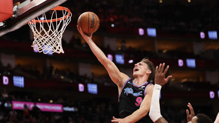 Mar 21, 2026; Houston, Texas, USA;  Miami Heat guard Pelle Larsson (9) scores a basket against Houston Rockets forward Jabari Smith Jr. (10) in the second half at Toyota Center. Mandatory Credit: Thomas Shea-Imagn Images